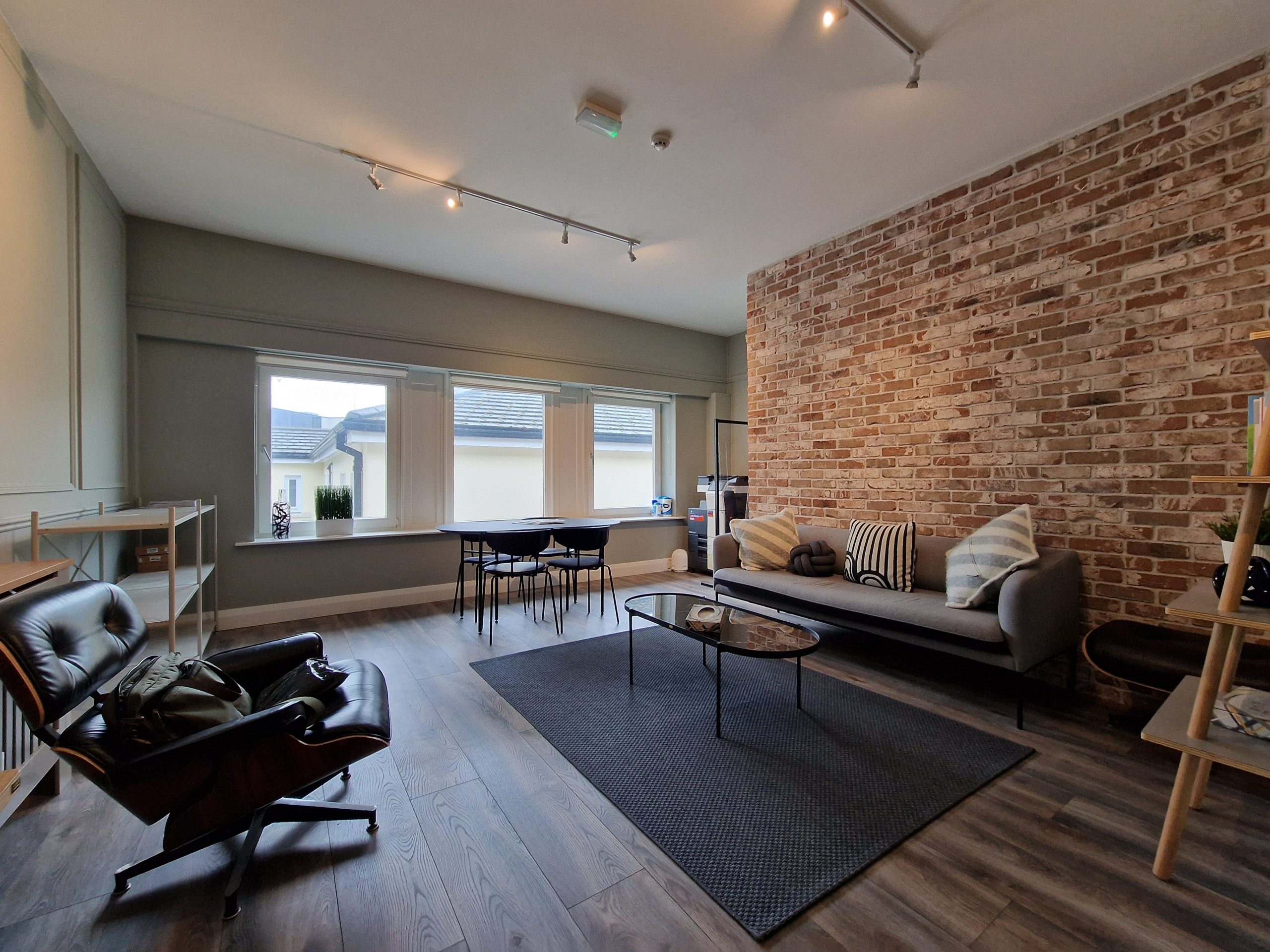 Room used for counselling services in Dublin with a couch and a brick wall
