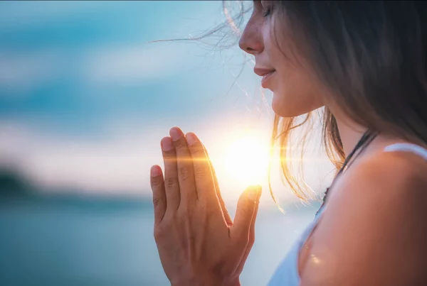 Woman practising Breathing Exercises while the sun sets
